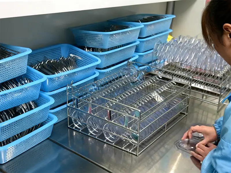 This shows our lenses after the first quality inspection, ready to be clipped for coating.