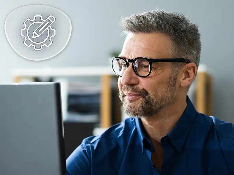 shows a scenario where a person is wearing blue blocking lenses while working.